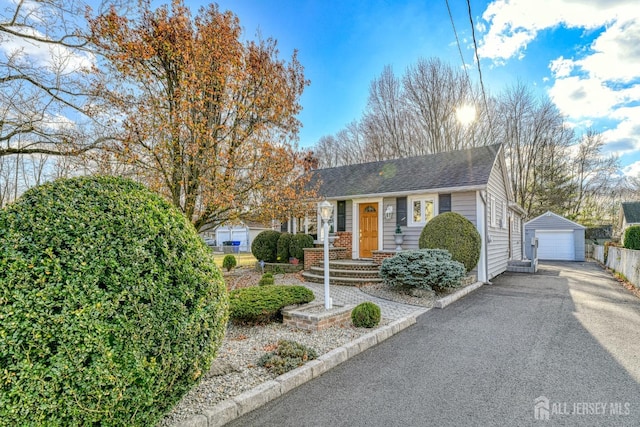 view of front of house with a garage and an outdoor structure