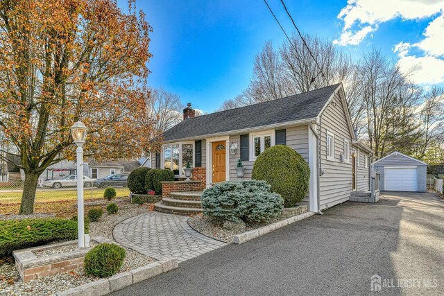 view of front of home featuring a garage and an outdoor structure