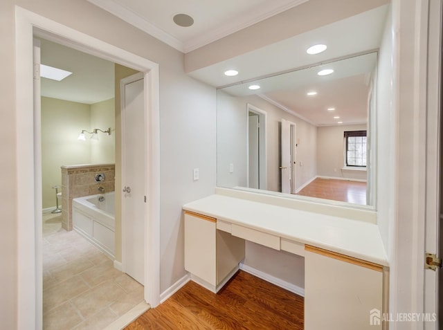 full bath featuring baseboards, ornamental molding, wood finished floors, a bath, and recessed lighting