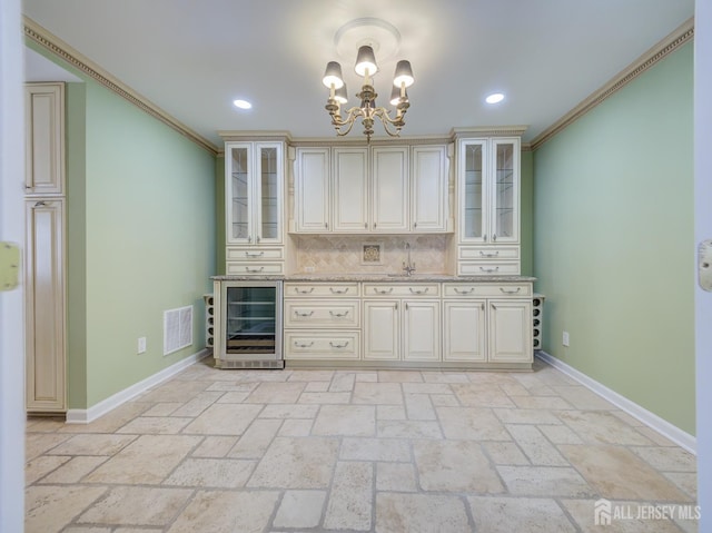 kitchen featuring visible vents, beverage cooler, decorative backsplash, and crown molding