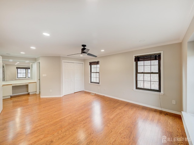 spare room featuring baseboards, a ceiling fan, ornamental molding, light wood-style floors, and recessed lighting