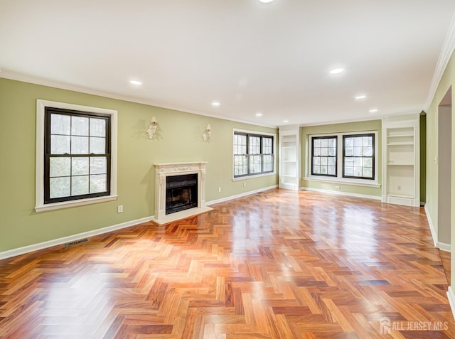 unfurnished living room featuring visible vents, baseboards, recessed lighting, a fireplace, and ornamental molding