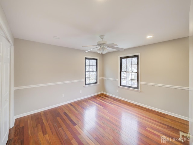 empty room featuring ceiling fan, recessed lighting, wood finished floors, and baseboards