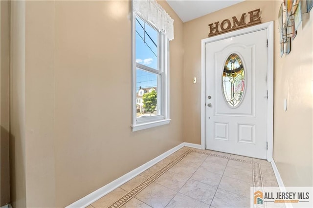 6 Hermann St, Carteret, NJ 07008 - entryway featuring baseboards, plenty of natural light, inlaid floor details, and light tile patterned floors