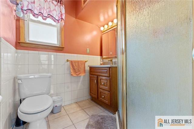 6 Hermann St, Carteret, NJ 07008 - full bath featuring toilet, vanity, a shower stall, tile patterned floors, and tile walls