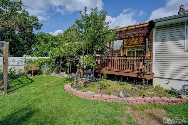 view of yard featuring a deck and fence