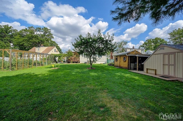 view of yard with an outbuilding and a shed