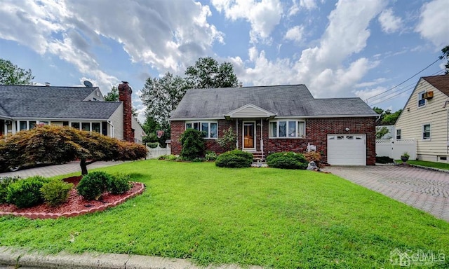 view of front of house with a front yard, fence, a garage, decorative driveway, and brick siding