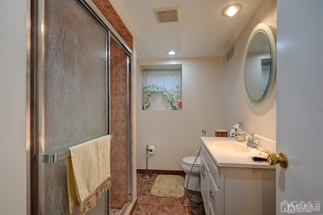 bathroom featuring visible vents, vanity, a shower stall, and toilet