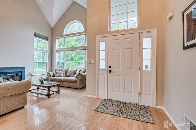 36 Jared Blvd, South Brunswick, NJ 08824 - entryway featuring high vaulted ceiling, hardwood / wood-style flooring, and a glass covered fireplace