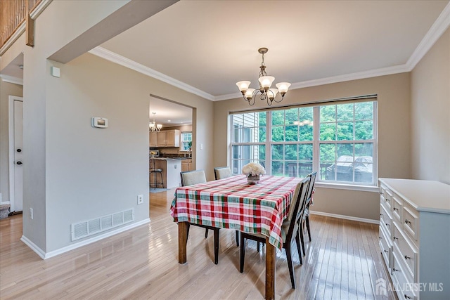 36 Jared Blvd, South Brunswick, NJ 08824 - dining area with a chandelier, light wood-type flooring, and crown molding
