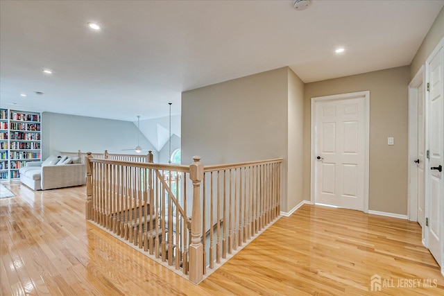 36 Jared Blvd, South Brunswick, NJ 08824 - hallway with light wood-type flooring, recessed lighting, and an upstairs landing