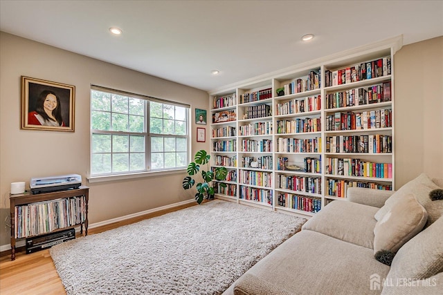 36 Jared Blvd, South Brunswick, NJ 08824 - sitting room with wood finished floors, recessed lighting, and bookshelves