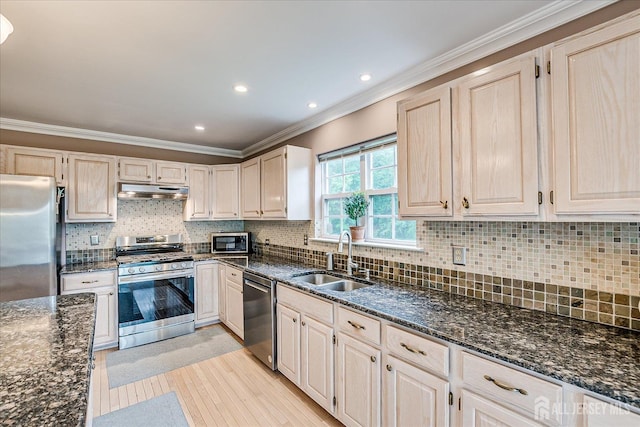 36 Jared Blvd, South Brunswick, NJ 08824 - kitchen with stainless steel appliances, crown molding, dark stone countertops, light wood-type flooring, and under cabinet range hood