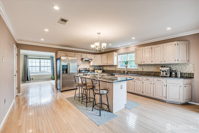 36 Jared Blvd, South Brunswick, NJ 08824 - kitchen featuring appliances with stainless steel finishes, ornamental molding, light wood finished floors, decorative backsplash, and a center island
