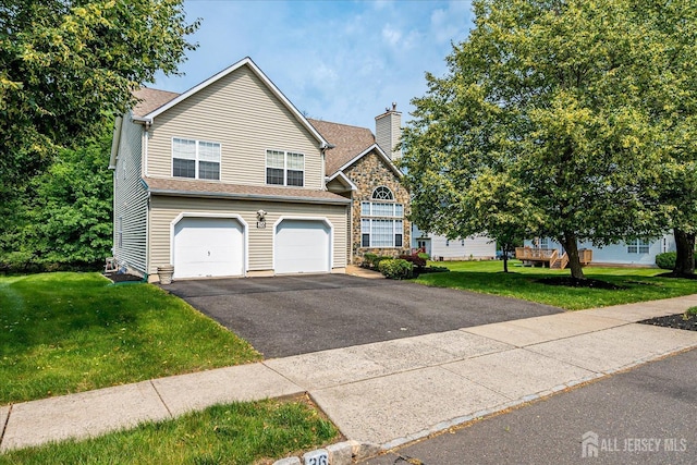 36 Jared Blvd, South Brunswick, NJ 08824 - view of front of property featuring driveway, a garage, a chimney, and a front yard