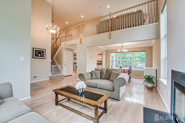 36 Jared Blvd, South Brunswick, NJ 08824 - living room with a chandelier, stairs, light wood-type flooring, recessed lighting, and ornamental molding