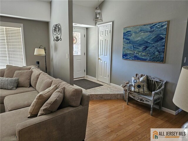 living room featuring lofted ceiling and hardwood / wood-style floors