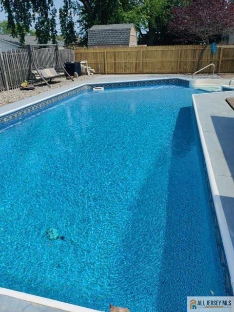 view of swimming pool featuring a fenced backyard and a fenced in pool