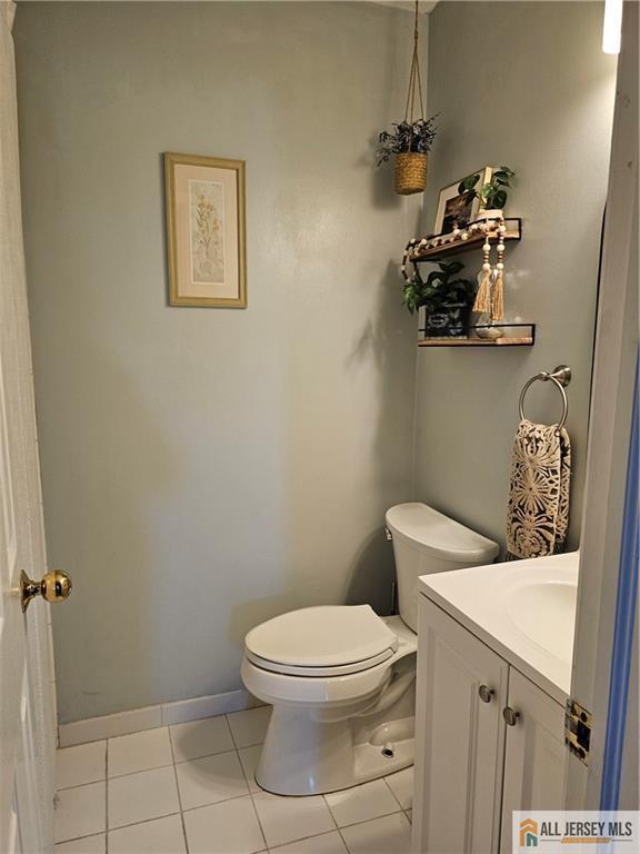 bathroom with vanity, tile patterned floors, and toilet