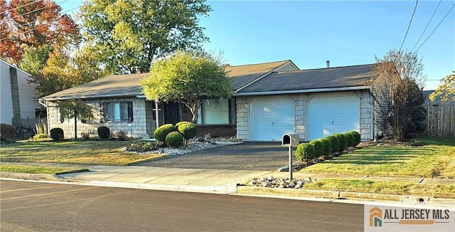 ranch-style home featuring a garage and a front yard