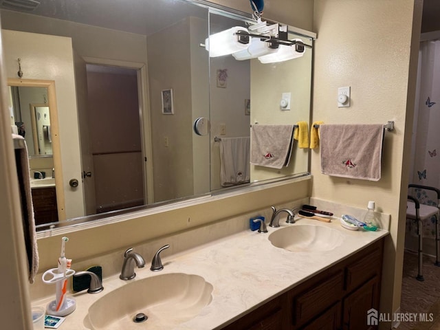 full bath featuring double vanity and a sink