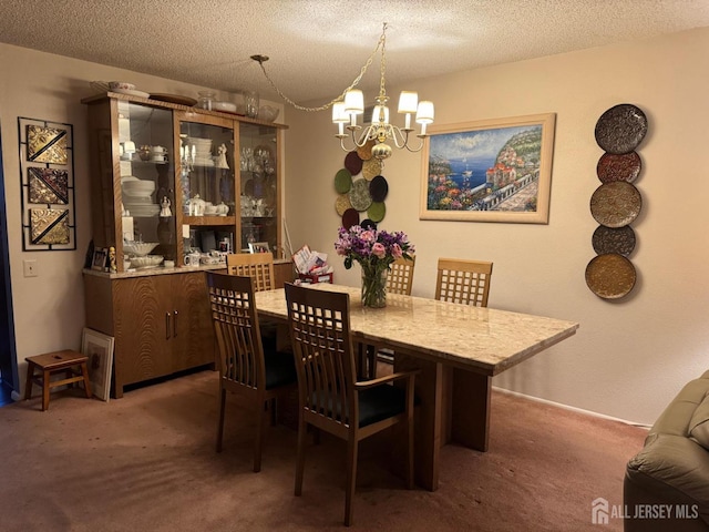 carpeted dining area featuring a textured ceiling and an inviting chandelier