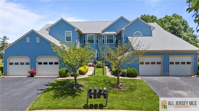 view of front of house featuring a garage and a front lawn