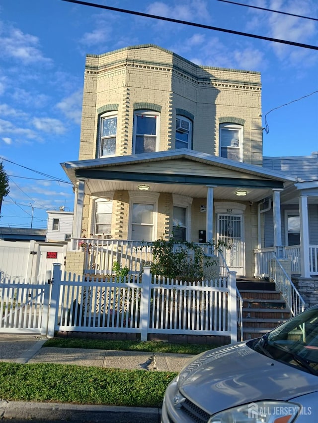 townhome / multi-family property featuring covered porch