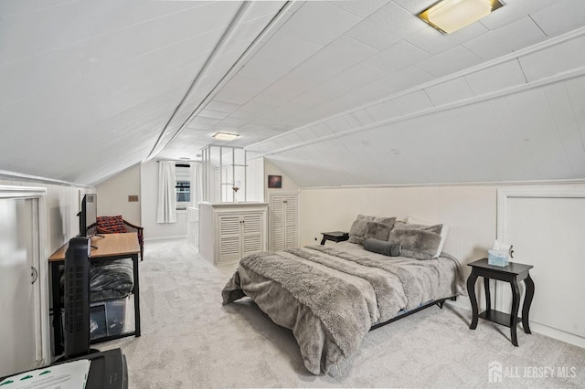 carpeted bedroom with vaulted ceiling