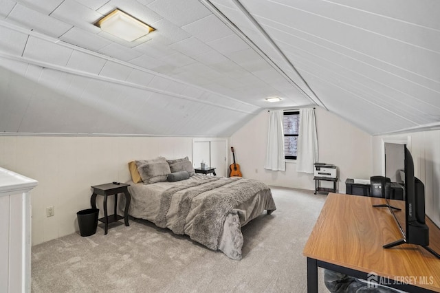 carpeted bedroom featuring vaulted ceiling