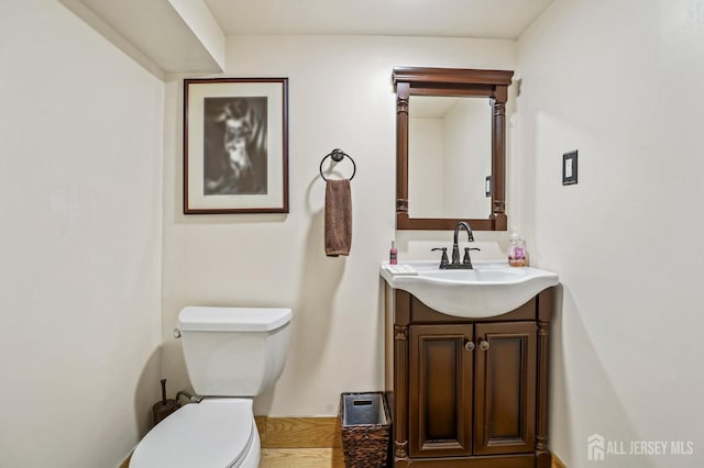 bathroom with toilet and vanity