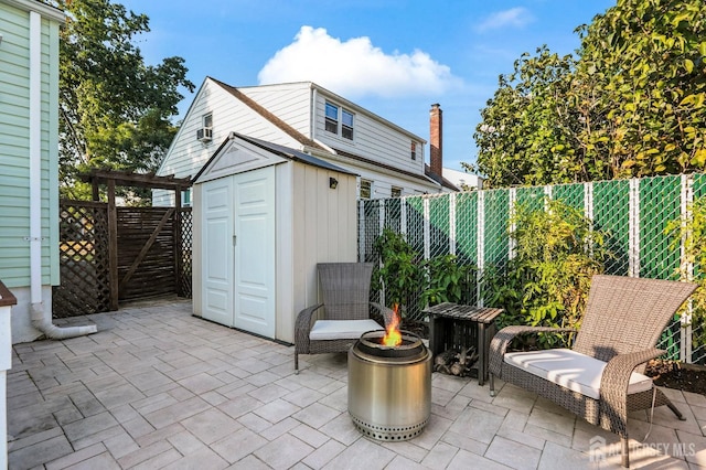 view of patio featuring a shed