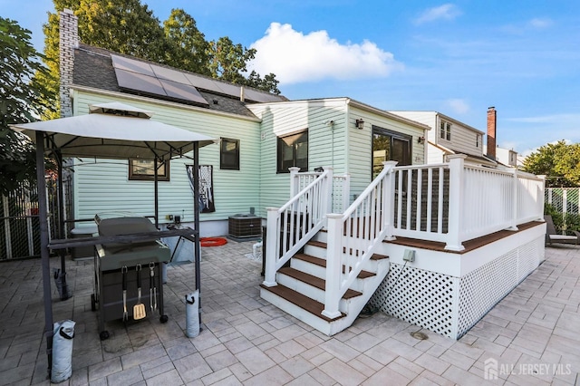 back of house featuring a patio, solar panels, cooling unit, and a gazebo