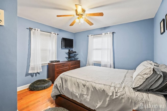 bedroom with ceiling fan and hardwood / wood-style floors