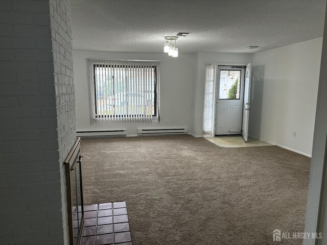 6-A Aspen Plz, Monroe, NJ 08831 - spare room featuring carpet flooring, baseboard heating, a textured ceiling, a baseboard heating unit, and baseboards