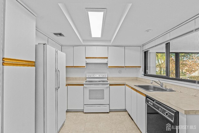 6-A Aspen Plz, Monroe, NJ 08831 - kitchen featuring white appliances, a sink, under cabinet range hood, light countertops, and white cabinets