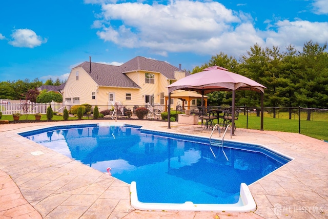 view of swimming pool featuring fence, a gazebo, and a patio area
