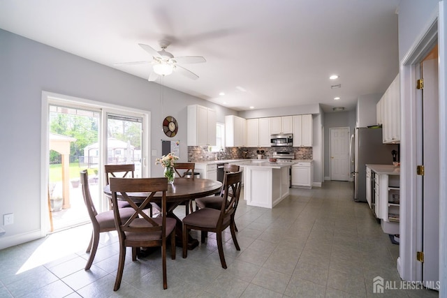 dining space featuring a ceiling fan, light tile patterned floors, recessed lighting, and baseboards