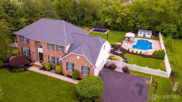 aerial view of property and surrounding area featuring a pool