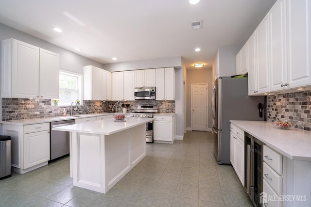 kitchen featuring stainless steel appliances, wine cooler, backsplash, light tile patterned floors, and recessed lighting