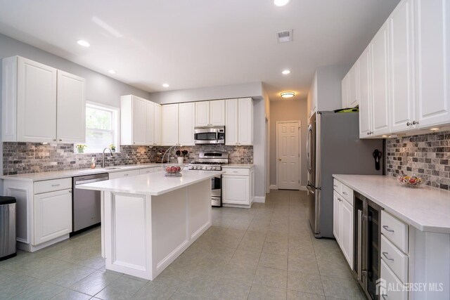 10 Magnolia Ct, Monroe, NJ 08831 - kitchen featuring appliances with stainless steel finishes, beverage cooler, backsplash, light tile patterned floors, and recessed lighting