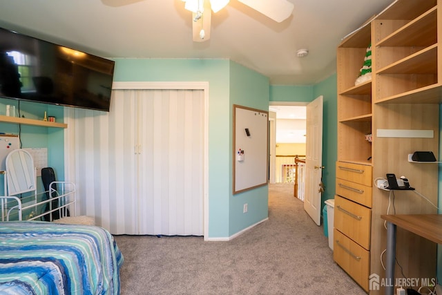 bedroom featuring light carpet, baseboards, and a ceiling fan