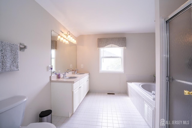 full bathroom featuring toilet, tile patterned floors, an enclosed shower, a bath, and double vanity