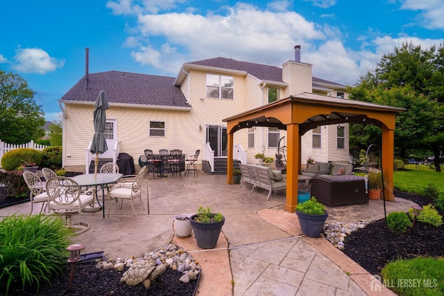 view of patio featuring an outdoor hangout area, a gazebo, entry steps, and outdoor dining area
