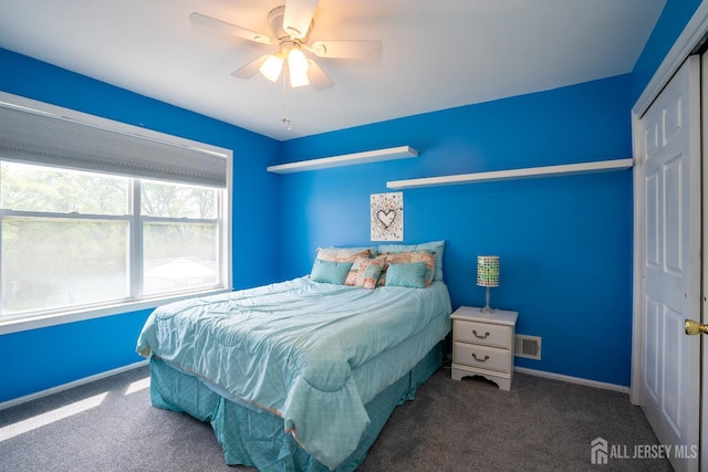 carpeted bedroom with a ceiling fan and baseboards
