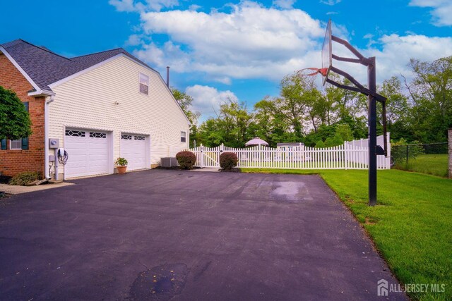 10 Magnolia Ct, Monroe, NJ 08831 - view of side of property featuring asphalt driveway, a garage, central air condition unit, and a gate
