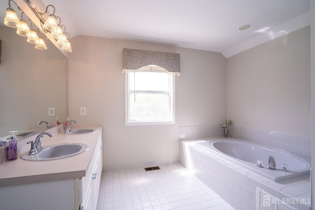 full bathroom with tile patterned flooring, a bath, baseboards, and double vanity