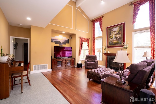 living area with high vaulted ceiling, a fireplace, tile patterned flooring, baseboards, and recessed lighting