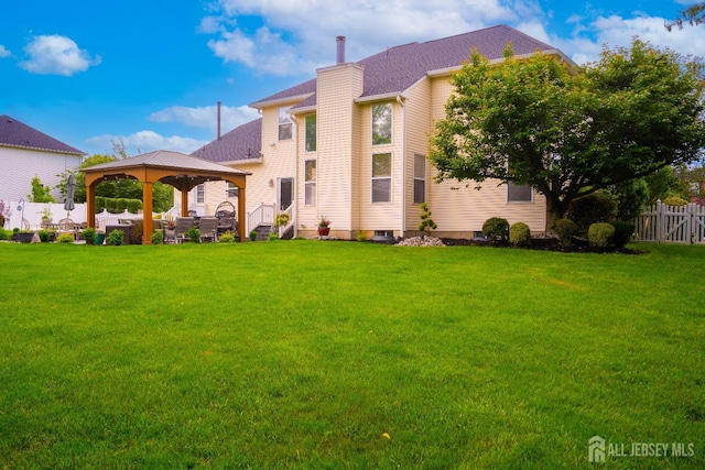 view of front of property featuring a gazebo and a chimney